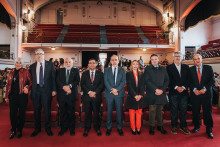 Autoridades Usach posan en foto e n Teatro Aula Magna. Atrás se divisa la marquesina del teatro.