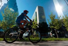 Ciclista pasando por al frente de unos edificios 