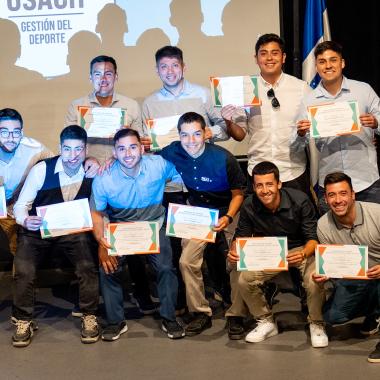 Foto grupal de deportistas de la universidad con sus diplomas de honor