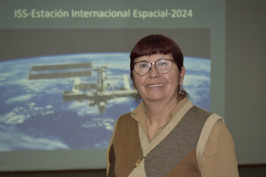 Académica Jenny Blamey. De fondo, una imagen del espacio.