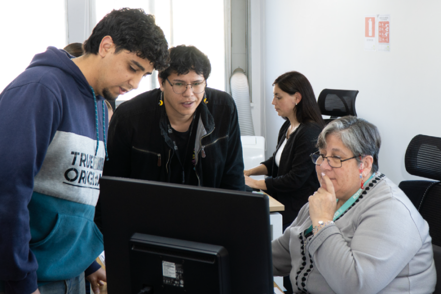 En la fotografía aparece una funcionaria de Bienestar del Personal, atiendo a dos jóvenes.
